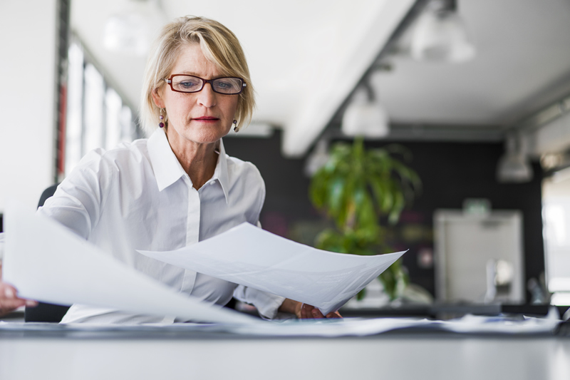 Woman with a white shirt holding papers