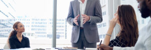 business man talks to coworkers in a conference room