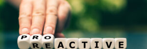 Tiles being flipped from the word "reactive" to the word "proactive"
